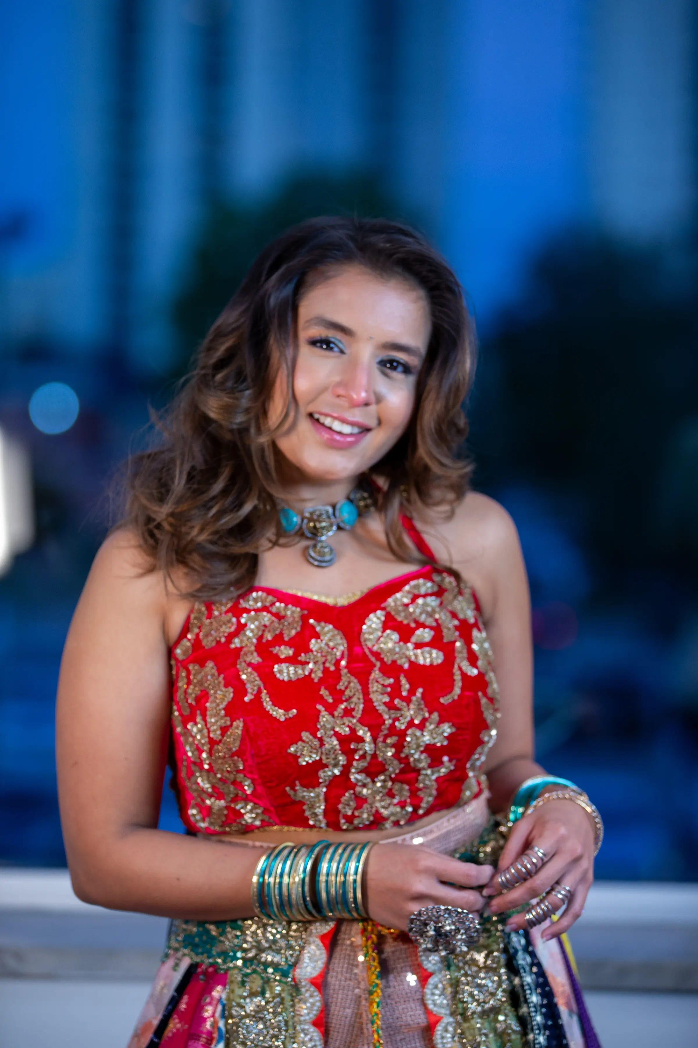 A portrait in red and gold, blue light behind.